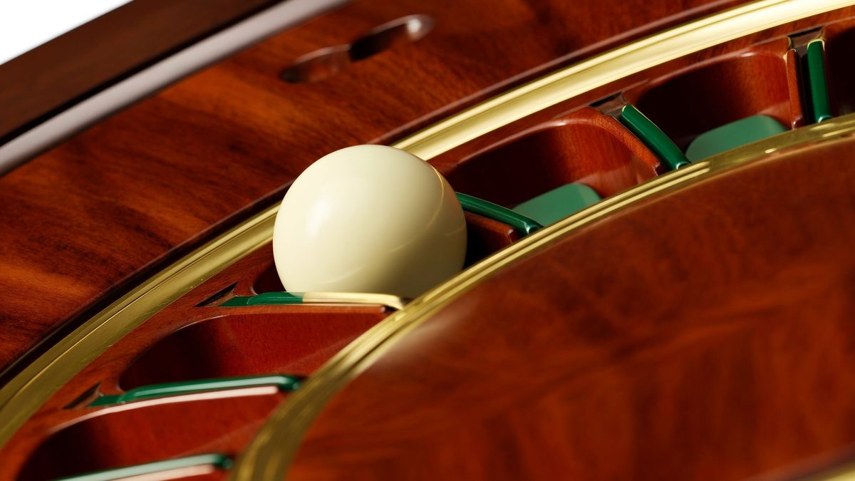 Close-up of a roulette wheel with the ivory ball at rest in one pocket